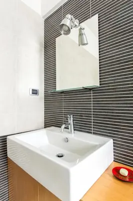 a bathroom with a white sink and a mirror at Art Loft Penthouse near Trastevere in Rome
