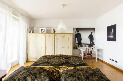 a bedroom with a bed and a desk in it at Art Loft Penthouse near Trastevere in Rome