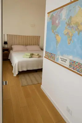 a room with a bed and a map on the wall at Casetta Beatrice Cozy Flat near Vatican in Rome