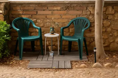 two green chairs and a table on a porch at Casetta Beatrice Cozy Flat near Vatican in Rome