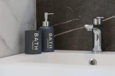 two bottles ofodorizers sitting on a bathroom sink at Boutique Domus Trastevere Penthouse in Rome
