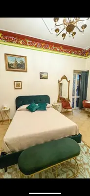 a bedroom with a large bed with a green ottoman at Pantheon Luxury Noble Apartment in Rome