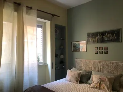 a bedroom with a bed and a window at Due Calzini in Rome