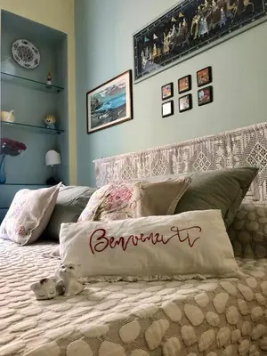 a bed with a pillow with the wordonement on it at Due Calzini in Rome