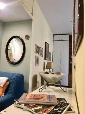 a living room with a blue couch and a table at Due Calzini in Rome