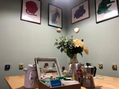 a table with a mirror and a vase of flowers at Due Calzini in Rome