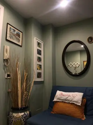 a living room with a blue couch and a mirror at Due Calzini in Rome