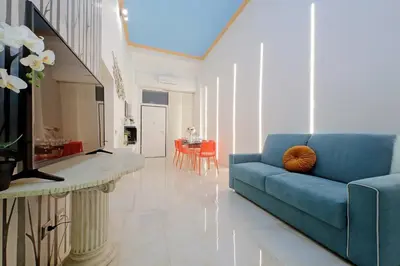 a living room with a blue couch and a table at Principe Amedeo piano terra in Rome