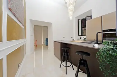 a kitchen with two bar stools and a counter at Principe Amedeo piano terra in Rome