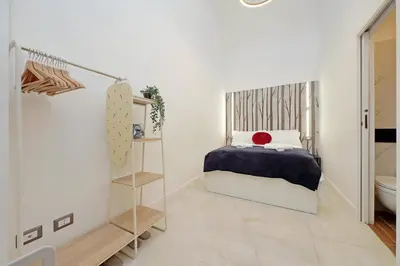 a small bedroom with a bed and a bathroom at Principe Amedeo piano terra in Rome