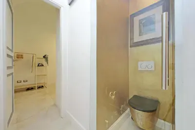 a hallway with a bathroom with a toilet in it at Principe Amedeo piano terra in Rome