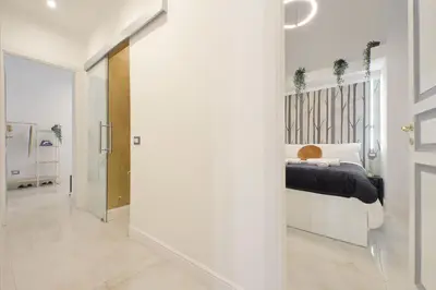 a bedroom with a bed in a white room at Principe Amedeo piano terra in Rome