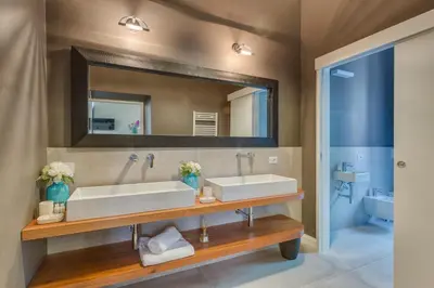 a bathroom with two sinks and a mirror at RomExperience Borgo Pio in Rome