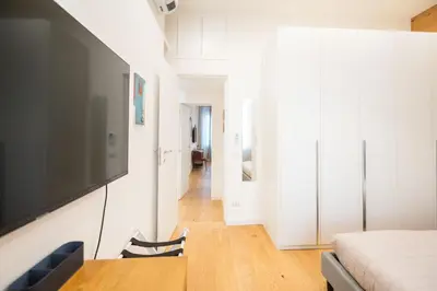 a bedroom with a flat screen tv on a wall at Barbra Suite Testaccio in Rome