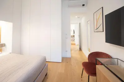a bedroom with a bed and a tv and a chair at Barbra Suite Testaccio in Rome