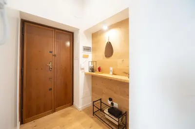 a hallway with a wooden closet and a wooden door at Barbra Suite Testaccio in Rome