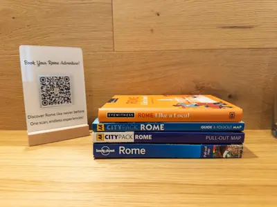 a stack of books sitting on a table next to a sign at Barbra Suite Testaccio in Rome