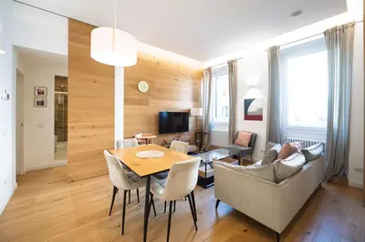 a living room with a table and chairs and a couch at Barbra Suite Testaccio in Rome