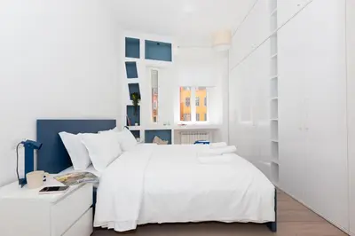 a white bedroom with a white bed and a desk at Quiet retreat in Trastevere - ZENO 45 in Rome