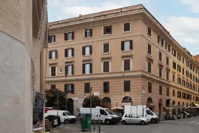 a large building with cars parked in front of it at Piazza Alessandria - FromHometoRome in Rome