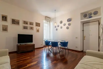 a living room with a table and chairs and a television at Piazza Alessandria - FromHometoRome in Rome