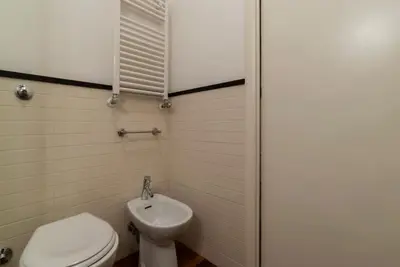 a bathroom with a toilet and a sink at Piazza Alessandria - FromHometoRome in Rome