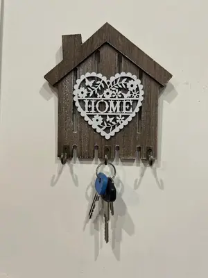 a heart shaped house with keys hanging on a wall at A Casa di Mario al Pigneto in Rome