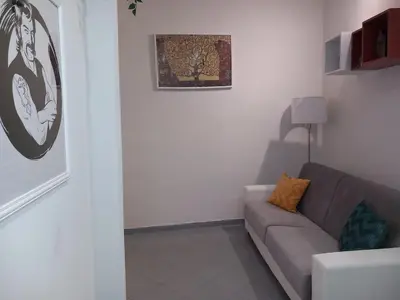 a living room with a couch and a picture on the wall at A Casa di Mario al Pigneto in Rome