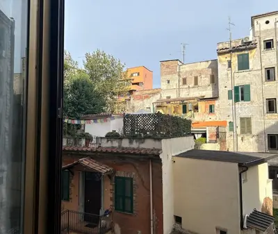 a view of a city from a window at A Casa di Mario al Pigneto in Rome