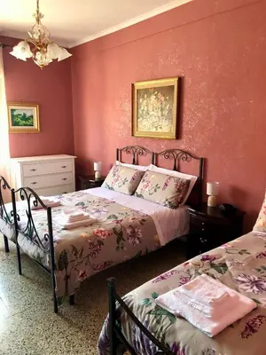 a living room with a large window with white curtains at MyHomeinRome - Zona Re di Roma in Rome