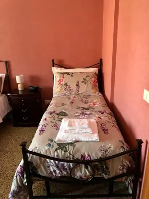 a bedroom with a bed and two night stands and two lamps at MyHomeinRome - Zona Re di Roma in Rome