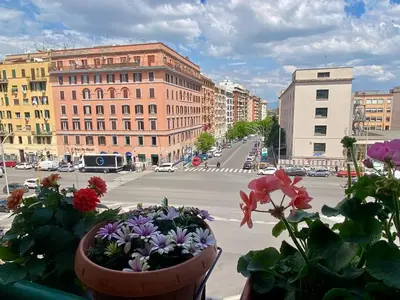 a view of a city with flowers on a balcony at MyHomeinRome - Zona Re di Roma in Rome