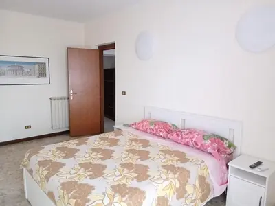 a bedroom with a large bed with pink pillows at WelcHomeRome in Rome