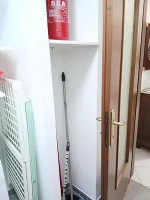 a mop leaning against a wall next to a door at WelcHomeRome in Rome