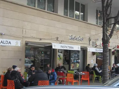 a group of people sitting outside of a restaurant at Porta Portese Trastevere Bright New Apartment in Rome