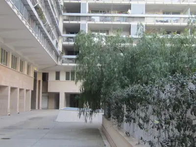 an empty hallway of an apartment building with a tree at Porta Portese Trastevere Bright New Apartment in Rome