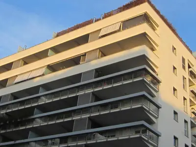 an apartment building with balconies on the side of it at Porta Portese Trastevere Bright New Apartment in Rome