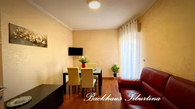 a living room with a table and a couch at Backhaus Tiburtina in Rome
