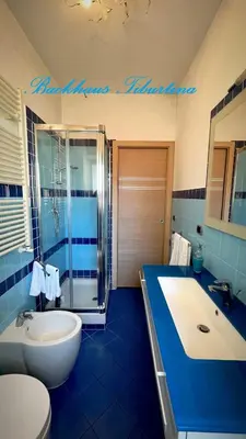 a bathroom with a tub and a sink and a toilet at Backhaus Tiburtina in Rome