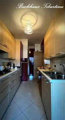 a large kitchen with a sink and a counter top at Backhaus Tiburtina in Rome