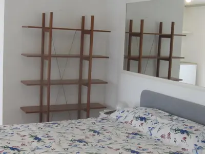 a bedroom with a bed and some shelves and a mirror at Penthouse in Trastevere - Entire House in Rome