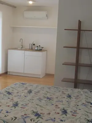 a room with a bed and a kitchen in it at Penthouse in Trastevere - Entire House in Rome