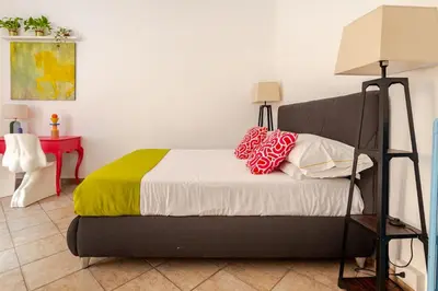 a bed with two pillows on it in a room at Funky 3BR Flat, Scenic Tram to Colosseum 7 Stops in Rome
