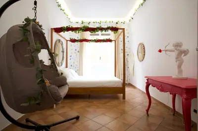 a living room with a chair and a window at Funky 3BR Flat, Scenic Tram to Colosseum 7 Stops in Rome