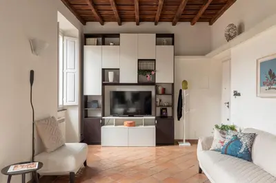 a living room with a couch and a tv at iFlat Trevi Charm, Elegant & Comfy Roman Escape in Rome