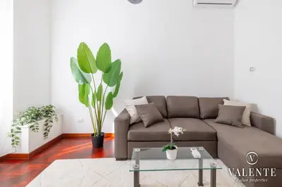 a living room with a couch and a table at Comfy and Elegant Apartment in Rome