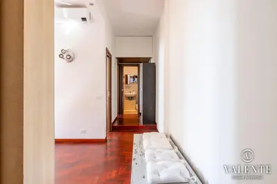 a hallway with a couch in the middle of a room at Comfy and Elegant Apartment in Rome