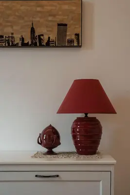 a lamp sitting on top of a dresser with a vase at Casa Matilde - WelcomeToRhome in Rome
