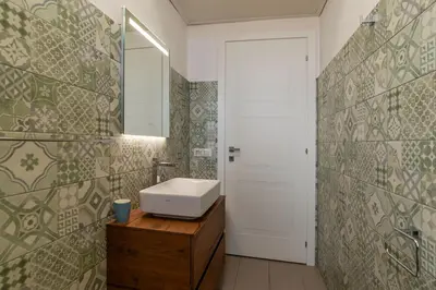 a bathroom with a sink and a mirror at Casa Matilde - WelcomeToRhome in Rome