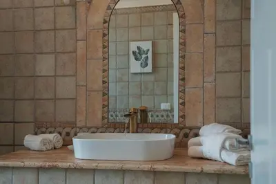 a bathroom with a sink and a mirror and towels at Casa Matilde - WelcomeToRhome in Rome